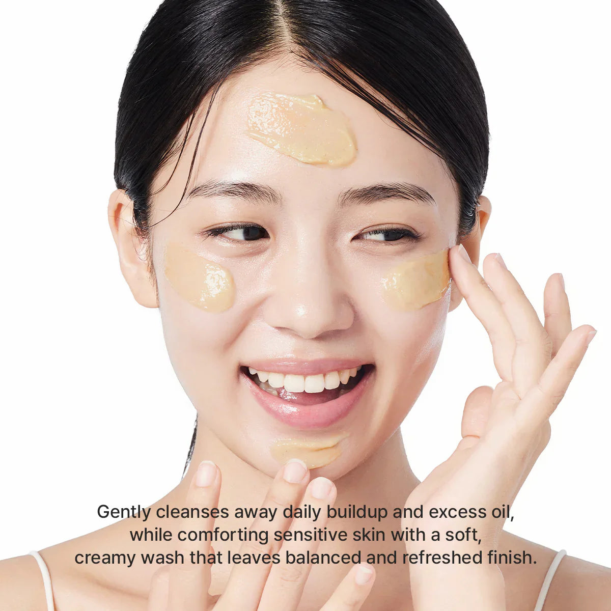 Woman applying cream patches to her face with a white background