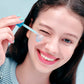Woman applying a EQQUALBERRY SERUM to her face with a blue applicator.