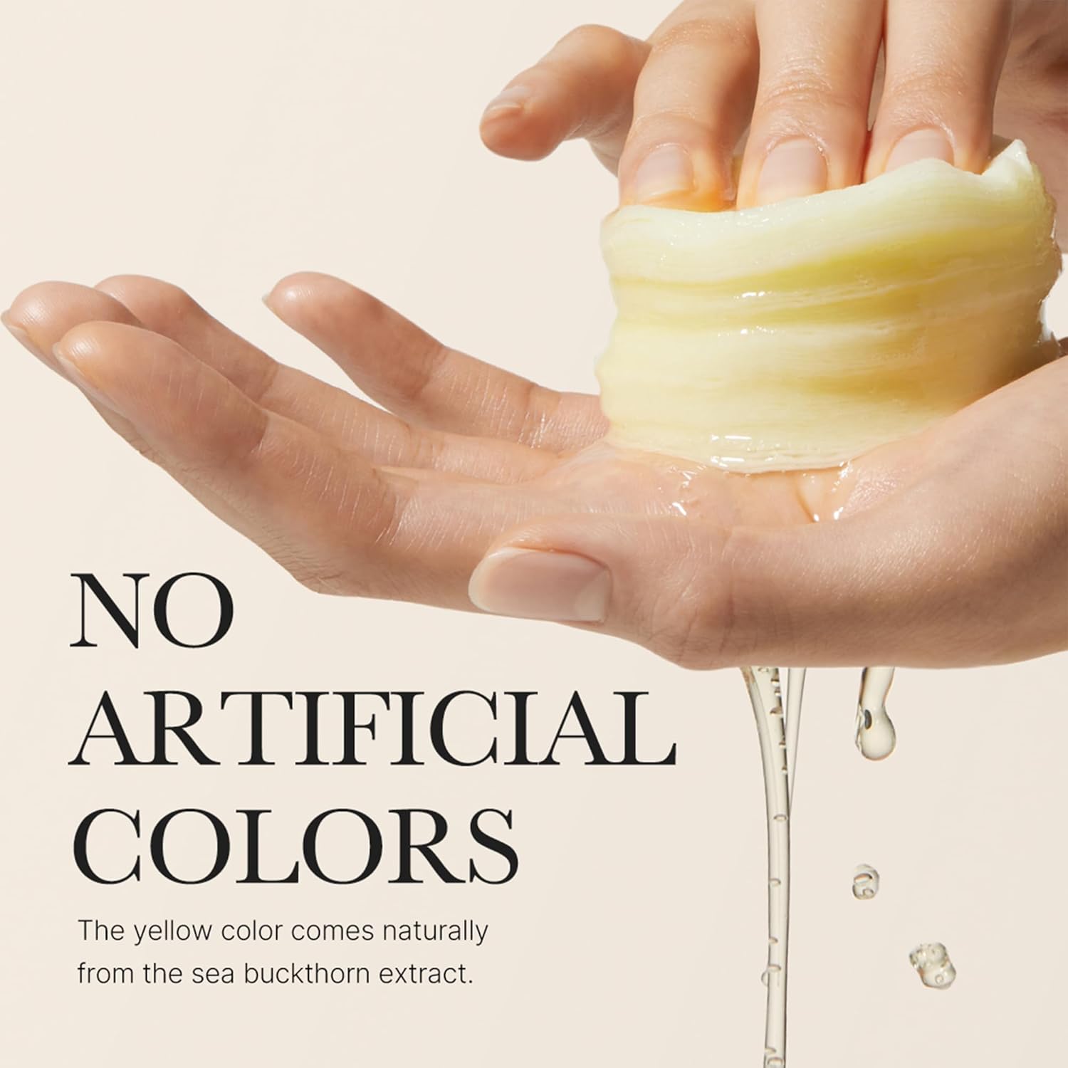 Hand holding a bar of soap with a natural yellow color, emphasizing the use of sea buckthorn extract.